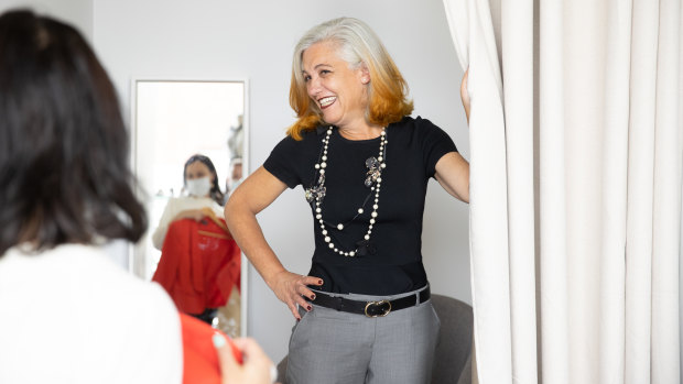 Marcia Scott, trying on an outfit at Fitted for Work, is one of thousands of recipients of quality work clothes, handbags and shoes donated by corporate women to help those seeking work to look the part every International Women’s Day.