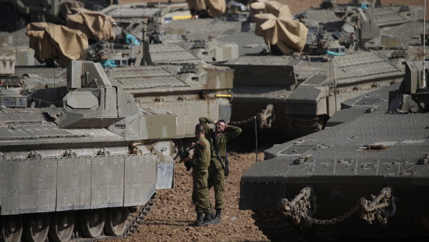 Israeli soldiers prepare their armoured vehicles at a gathering point near the Israel-Gaza Border on Wednesday.