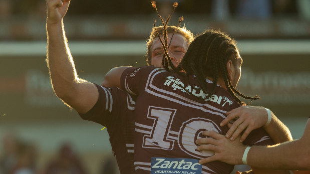 One game at a time: Trbojevic celebrates with try scorer Martin Taupau against the Knights.