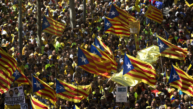 Demonstrators wave esteladas (independence flags) in Barcelona on Sunday.