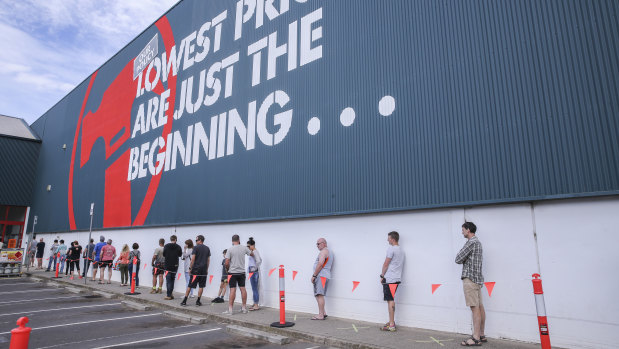 Shoppers practice social distancing outside a Bunnings store in Croydon on Sunday.