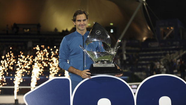 Roger Federer with trophy No.100.