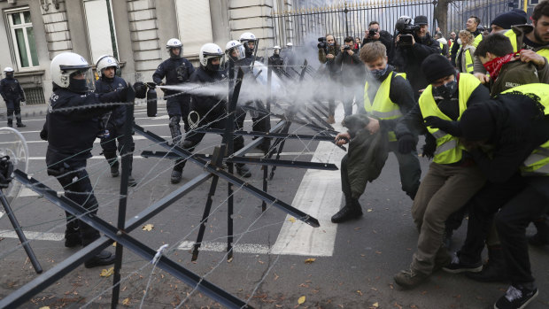 Police spray tear gas at demonstrators during a protest in Brussels on Friday.