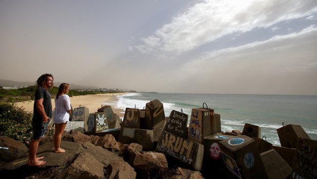 Scott Fuller and Natalie Beekmann watch a dust storm cloud that moved across western NSW and blanketed Wollongong on Thursday.