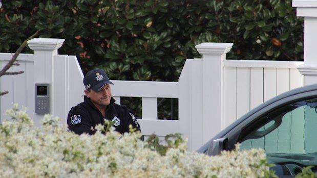 The home in Clayfield has entrances onto two different streets, with police seen at both on Saturday morning.