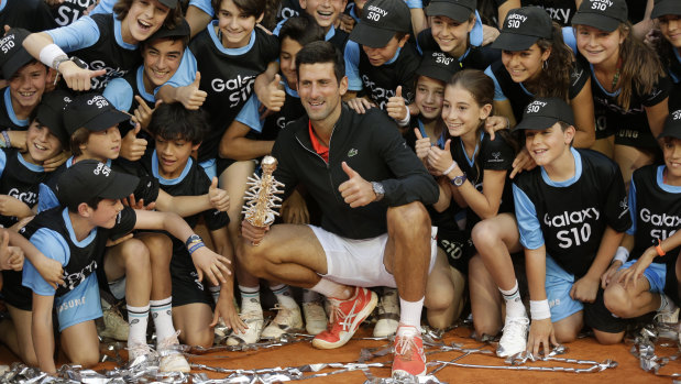 Novak Djokovic with the ball kids after winning the Madrid Open.