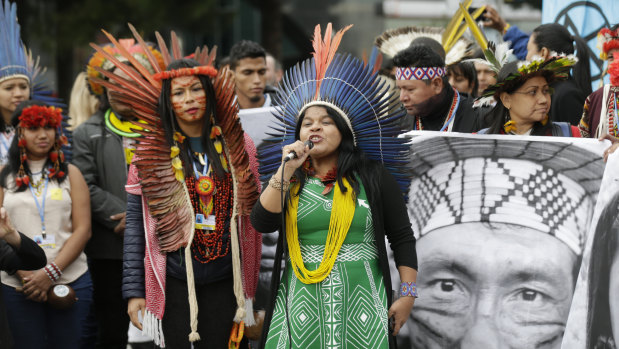 Brazilian indigenous leader Sonia Guajajara speaks alongside other activists in a protest outside the COP25 Climate summit in Madrid, Spain.