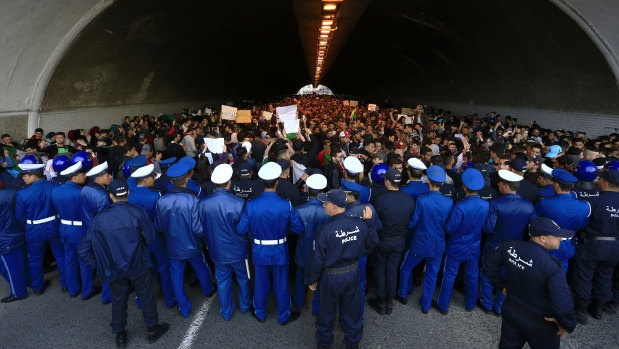 Algerian police forces block a tunnel where hundreds of students gather in central Algiers to protest against Algerian President Abdelaziz Bouteflika.