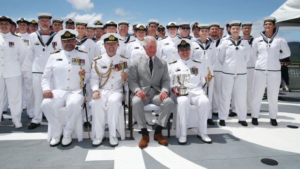 Prince Charles sits with (left to right) Commander Adam Muckalt, Rear Admiral Jonathon Meada, and Lieutenant Commander Sean Batilana, after presenting the Gloucester Cup to the Blue Crew on board the HMAS Leeuwin at the HMAS Cairns base on Sunday.