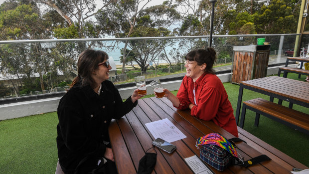Melbourne tourists Natalie Tarzia and Katherine Marshall  enjoy a beer at Lorne.