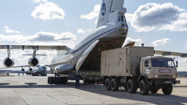A military truck loads on board of an Il-76 cargo plane in Chkalovsky military airport outside Moscow, Russia.