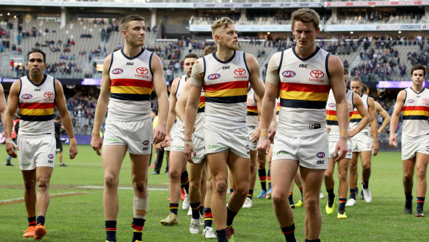Hard road ahead: Adelaide players leave the field after the round 12 loss to Fremantle.
