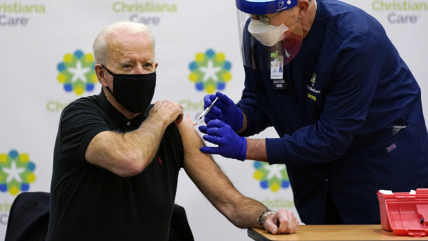 Focused: President-elect Joe Biden receives his second dose of the coronavirus vaccine from Chief Nurse Executive Ric Cuming in Newark on Monday.