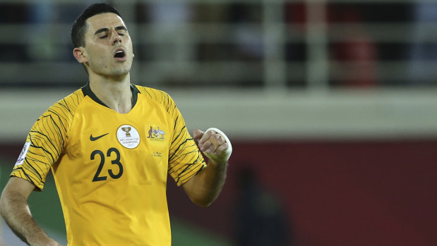 Absentee: Tom Rogic, in action against Uzbekistan, will miss Australia's quarter-final.