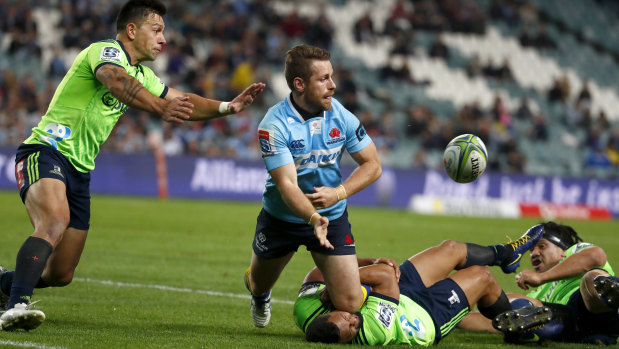 Confidence boost: Bernard Foley offloads during a free-flowing win for the Waratahs over the Highlanders.