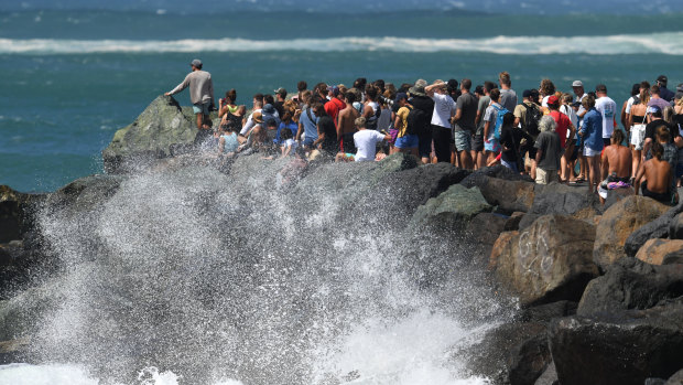 Crowds of people watching the waves at Kirra on the Gold Coast on Saturday.