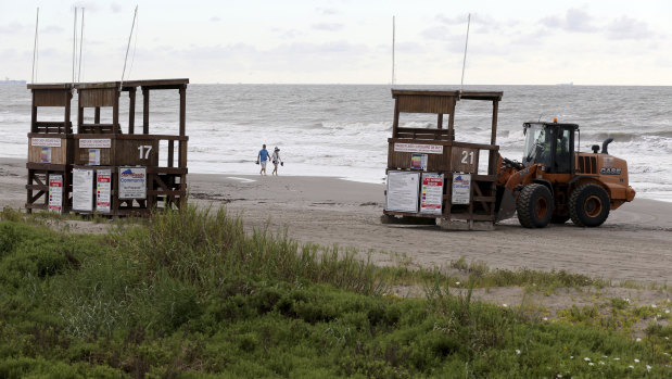Park board crews move the lifeguard towers off the beach in Galveston, Texas.
