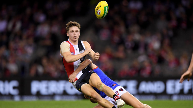 Downward spiral: St Kilda's Jack Billings on the receiving end of a Melbourne tackle at Etihad Stadium.