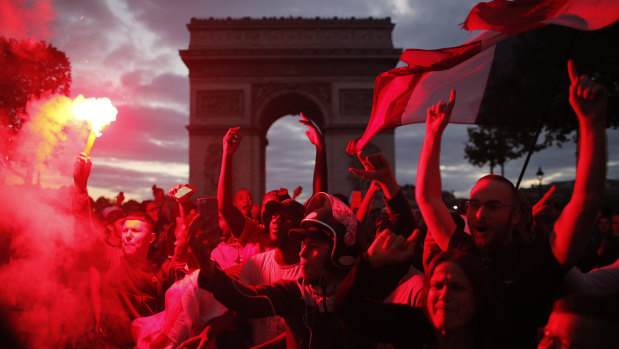 France supporters celebrate on the Champs-Elysees.