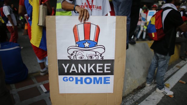 A supporter of President Nicolas Maduro holds a "Yankee go home" sign  in Caracas, Venezuela.