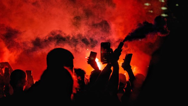 Fans light flares in Fed Square during the men’s 2023 World Cup.