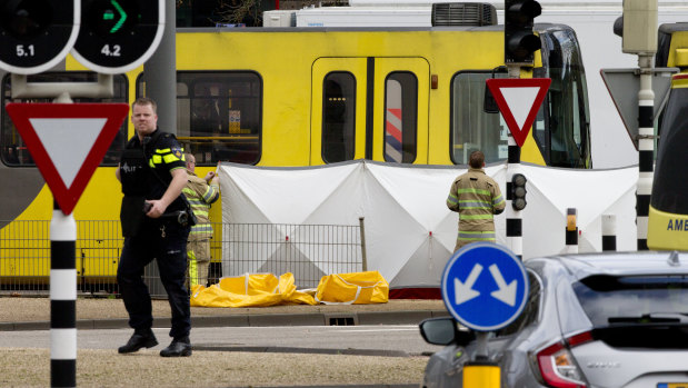 Rescue workers are installing a screen on the scene following a shooting in Utrecht, Netherlands.