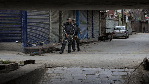 Indian paramilitary soldiers stand guard at a closed market in central Srinagar, Indian controlled Kashmir, on Tuesday.