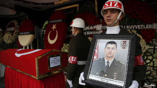 Turkish soldiers stand in vigil next to the national flag-draped coffin of 24-year old Muhammed Ali Kalo during his funeral procession in Istanbul on Saturday.