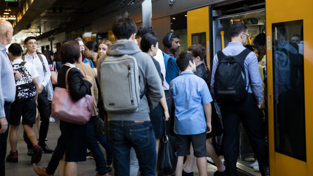 Passengers board a train at Chatswood station this week.