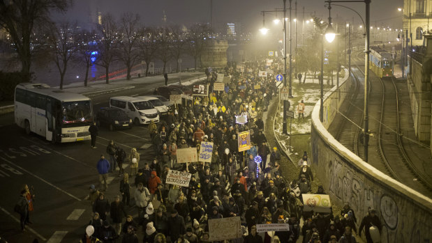 Protesters walk along a street during an anti-government march in central Budapest, Hungary.