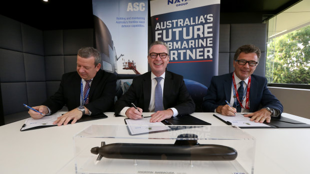 Naval Group Australia CEO John Davies, Minister for Defence Christopher Pyne and ASC CEO Stuart Whiley sign a working agreement for Australia's future submarines project.