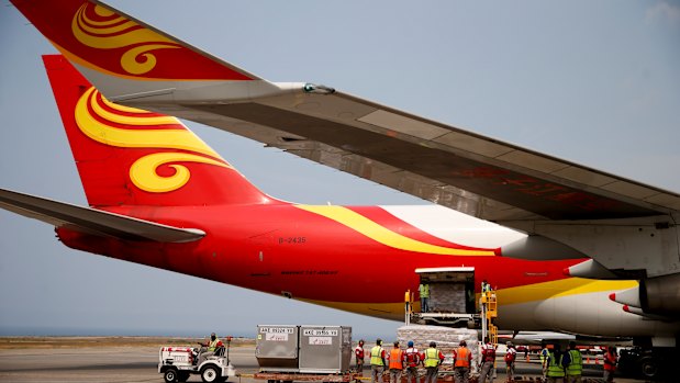 Workers unload medical supplies from a Chinese plane at the Simon Bolivar International Airport in Maiquetia, near Caracas, Venezuela.