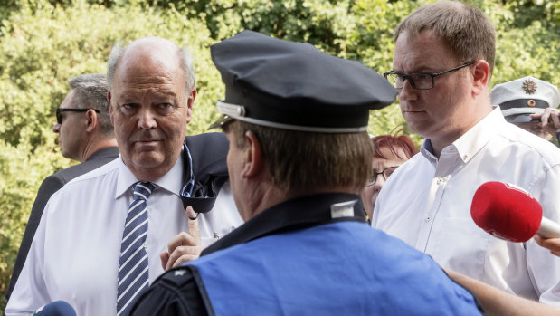 Hans-Joachim Grote, left, minister of the interior of Schleswig-Holstein, and Luebeck Mayor Jan Lindenau are briefed by police at the scene.