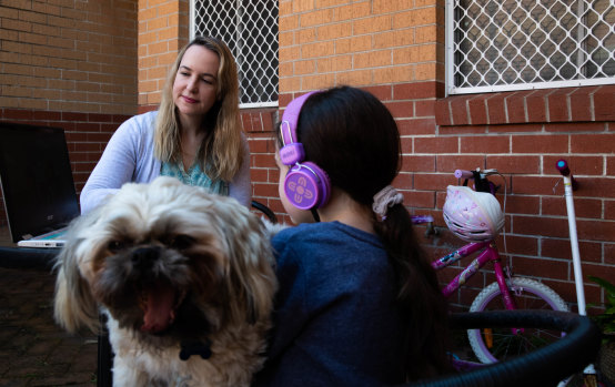 Hilary Brainard, her daughter Emerson and dog Teddy have been living and working through screens during Sydney’s lockdown. 