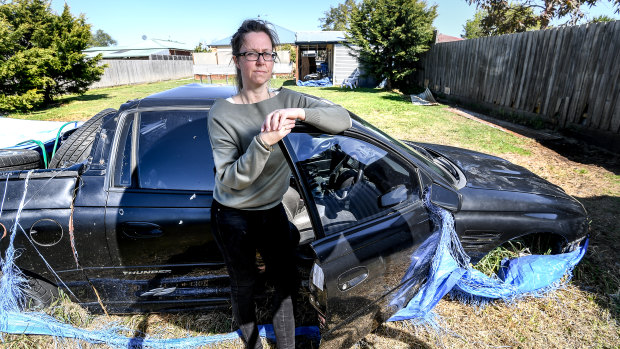 Nicole George with her husband's wrecked ute.