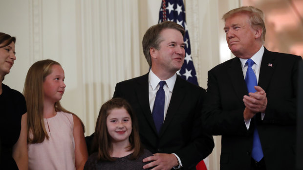President Donald Trump stands with Supreme Court nominee Judge Brett Kavanaugh and his family in the East Room of the White House earlier this month.
