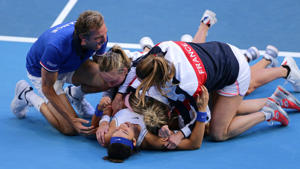 True Blues: A delighted French team celebrate after Caroline Garcia and Kristina Mladenovic won the deciding doubles match against Australia's Ashleigh Barty and Samantha Stosur.