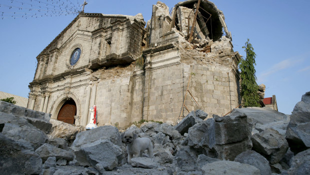 The damage of St Catherine church, with its headless statue, is seen following Monday's 6.1 magnitude earthquake in the Philippines.
