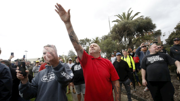 A protester issues a Nazi salute.