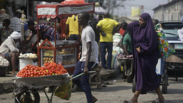 People walk, in a market in Lagos, Nigeria.
