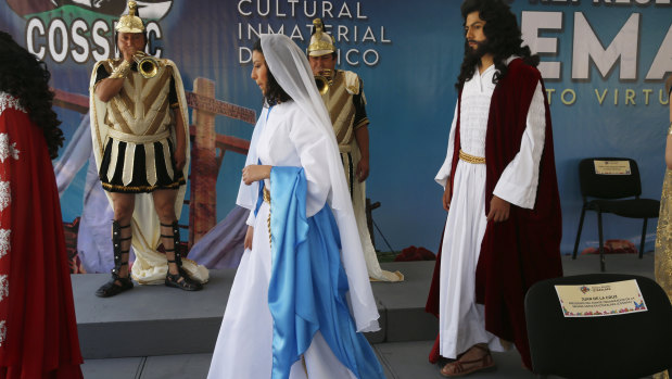 A couple playing the role of Jesus Christ and Mary walk in the Fuego Nuevo Museum during a presentation of the actors of the Stations of the Cross Passion Play in  Mexico City. 