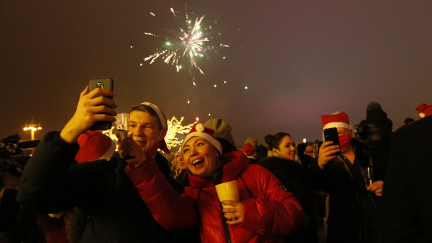 Passengers of a party bus celebrate New Year after driving through Moscow, Russia. While restaurants and entertainment venues were closed, Muscovites look for ways to bend the coronavirus restrictions. 
