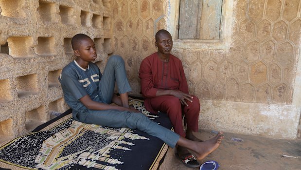 Usama Aminu, 17, a kidnapped student of Government Science Secondary School who escaped from bandits, left, and his father Aminu Male.