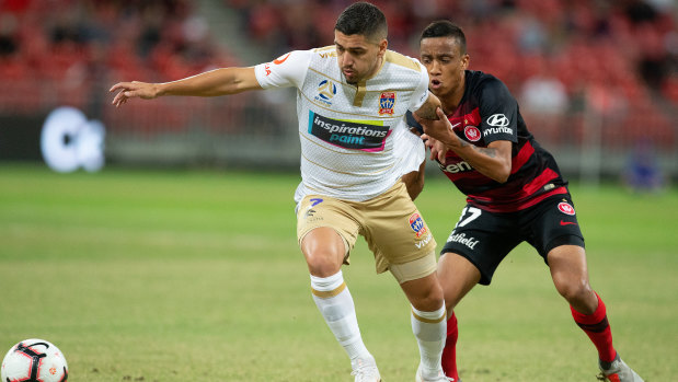 Tussle: Dimitri Petratos of the Jets is challenged by Keanu Baccus of the Wanderers.