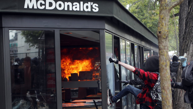 A McDonald's restaurant is hit with petrol bombs thrown by activists during the traditional May Day rally in the centre of Paris.