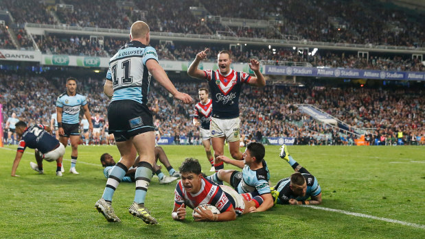 Charged: Latrell Mitchell crosses for the Roosters at Allianz Stadium.