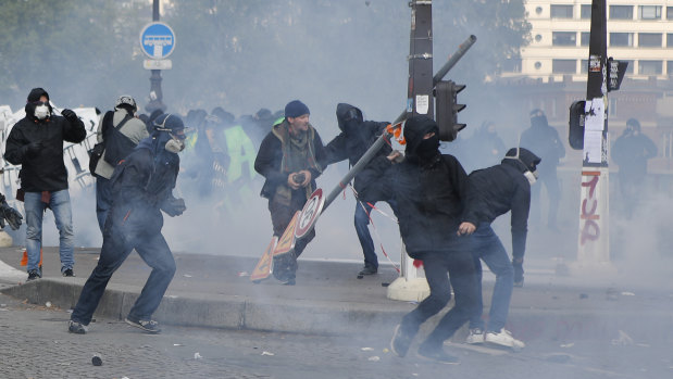 Activists clash with riot police during the traditional May Day rally in Paris on Tuesday.
