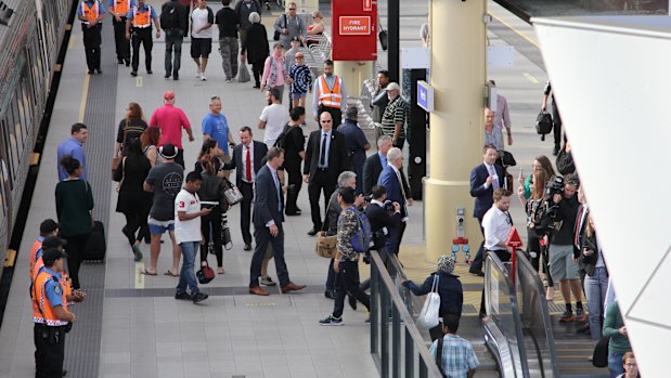 The politicians wander through the rail station.