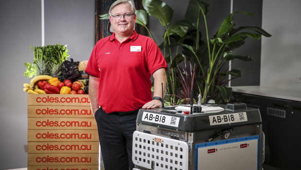 Coles chief Steven Cain with one of the 'daleks' that will pick online grocery orders. 