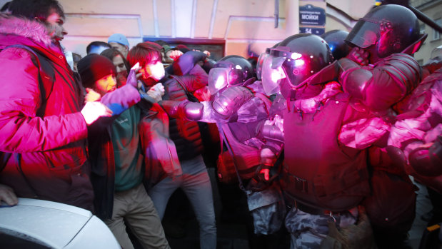 People clash with police during a protest in support of Alexei Navalny in St Petersburg, Russia. 